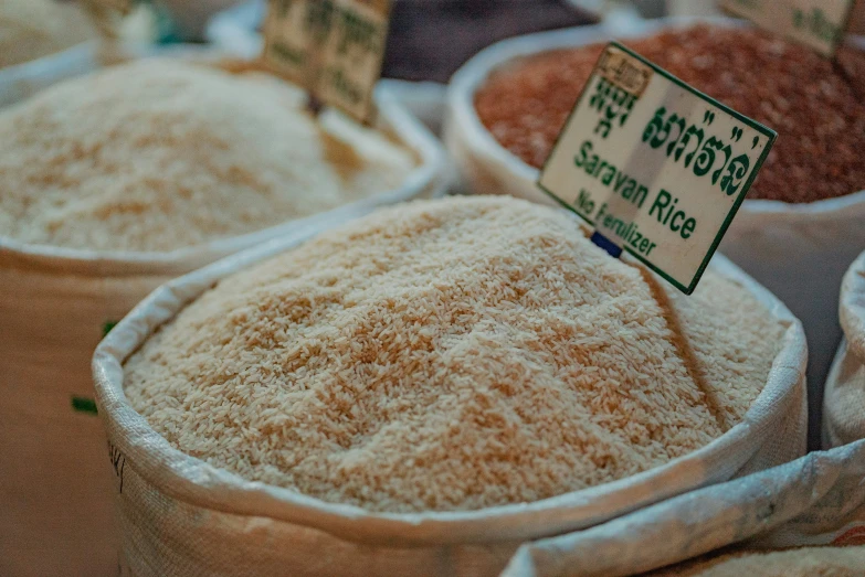 several sacks of ground rice on display at a market