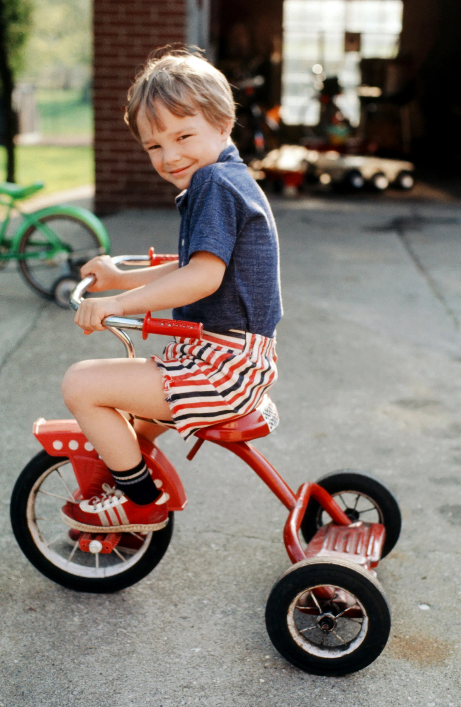 there is a child on a little red tricycle