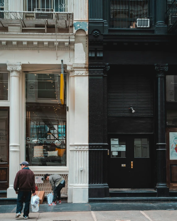 a group of people on the sidewalk with bags