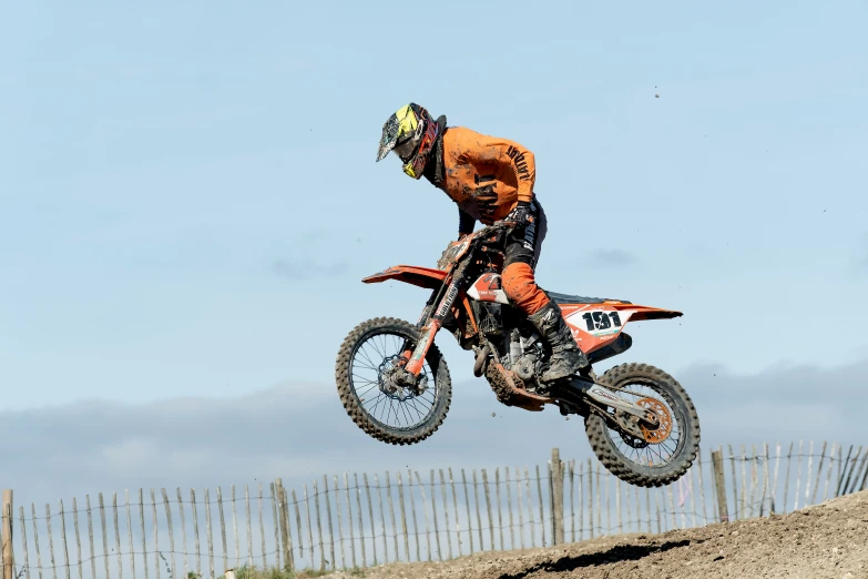 a man jumping in the air on a dirt bike