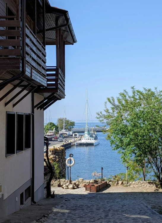 a stone steps leading to a lake with a sailboat