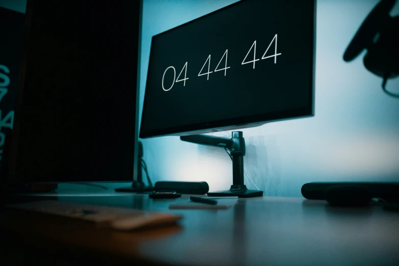 a desk that has a monitor, keyboard and mouse on it