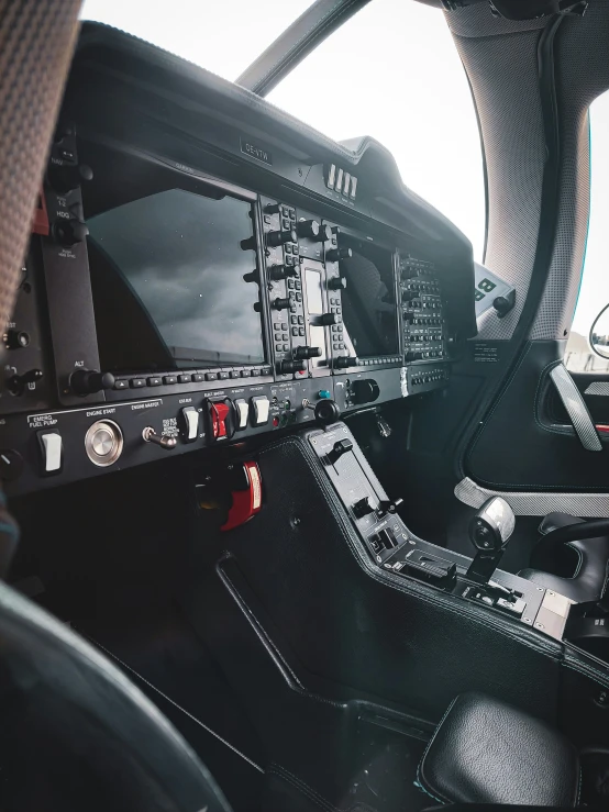 an airplane cockpit with black leather seats and dashboard controls