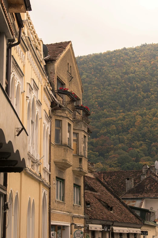 a view of a building with many windows with mountain in the background