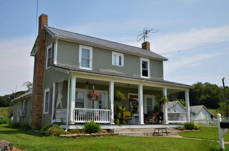 a very pretty house with two porches and pillars