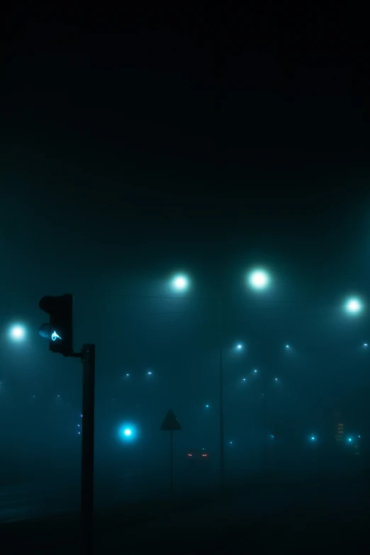 the stop light is on in the foggy night