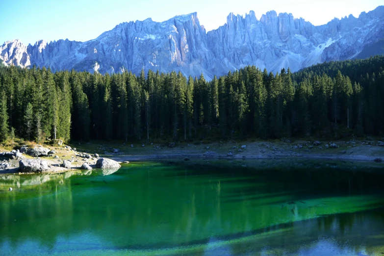 lake surrounded by mountains with green water