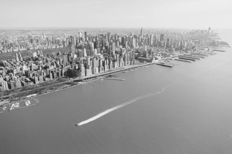 black and white pograph of city with boats in waterway