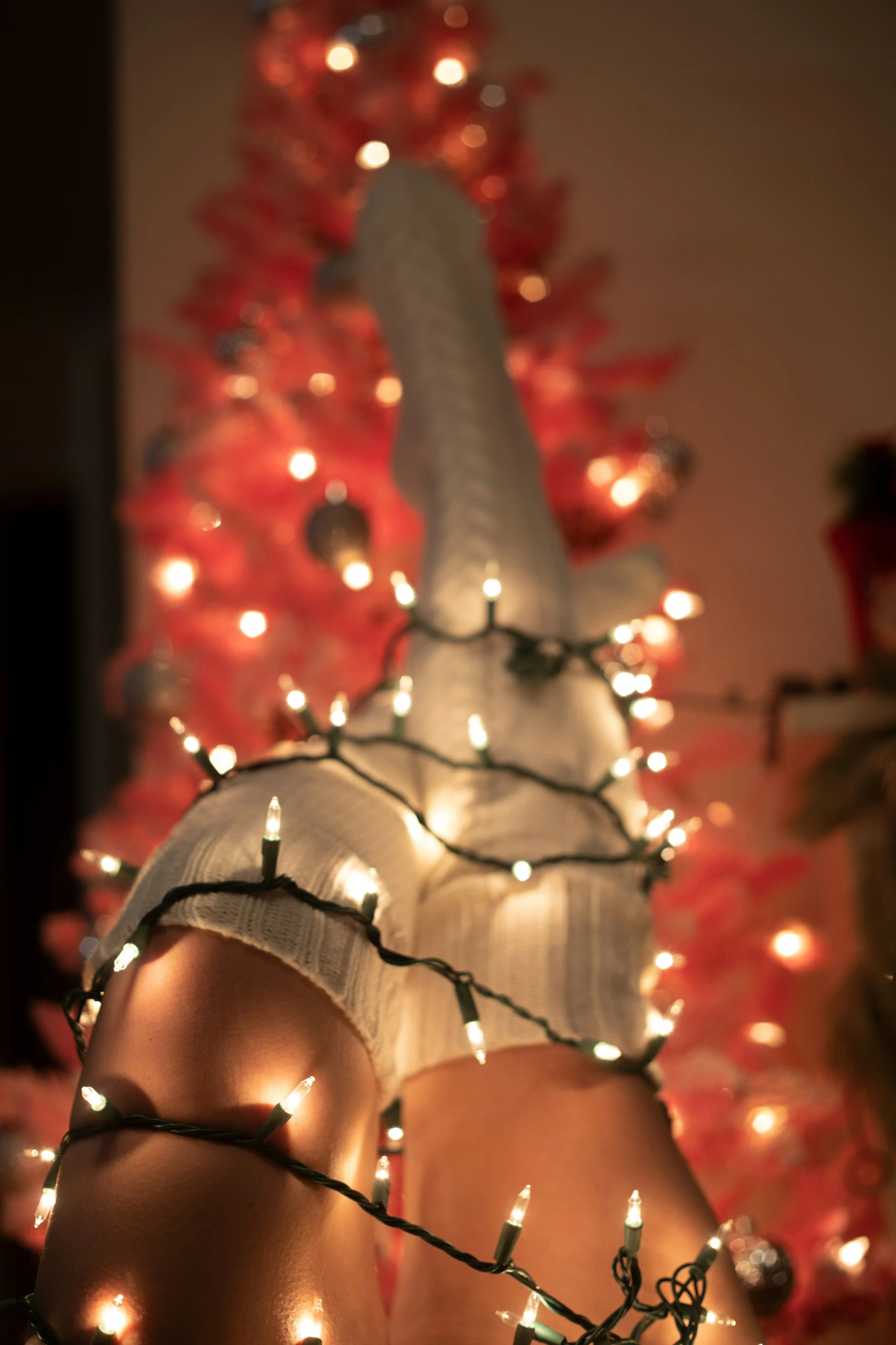 a christmas tree with lights and a large object