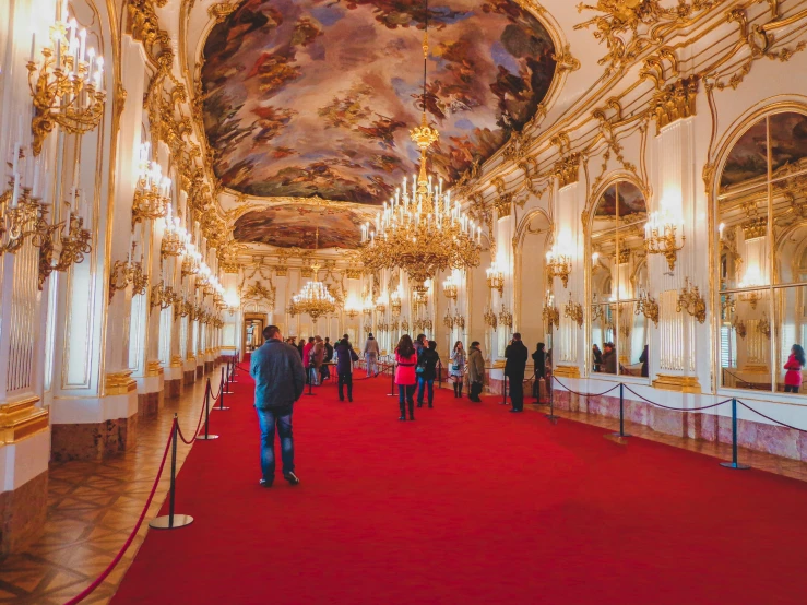 a red carpet and gold accents give visitors a glimpse at an elaborately designed building