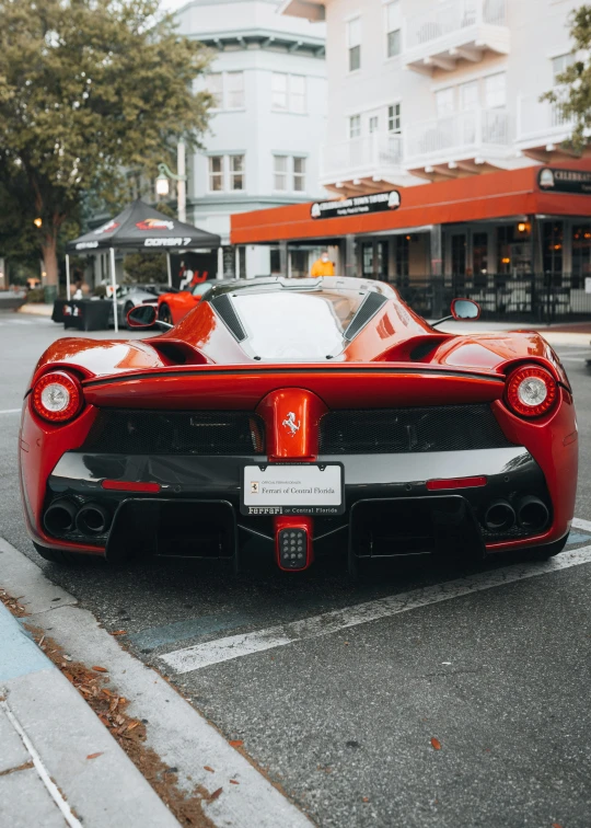 a large red sports car on a street