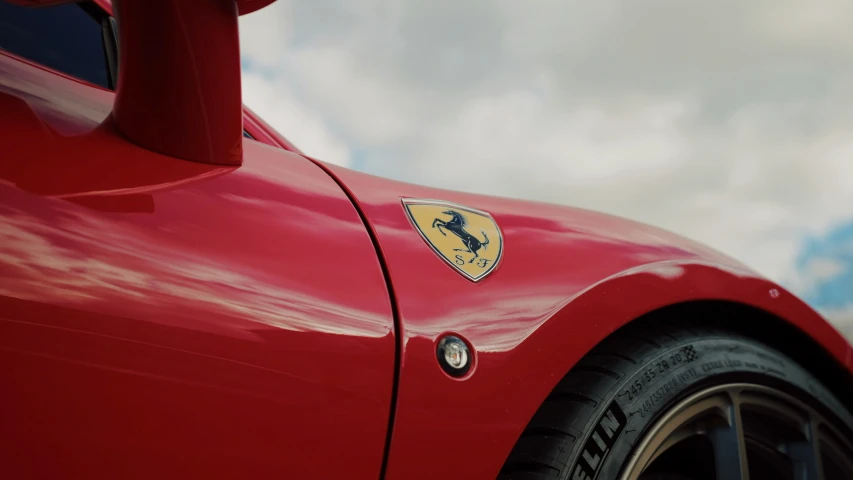 a red ferrari sports car with gold foil emblem