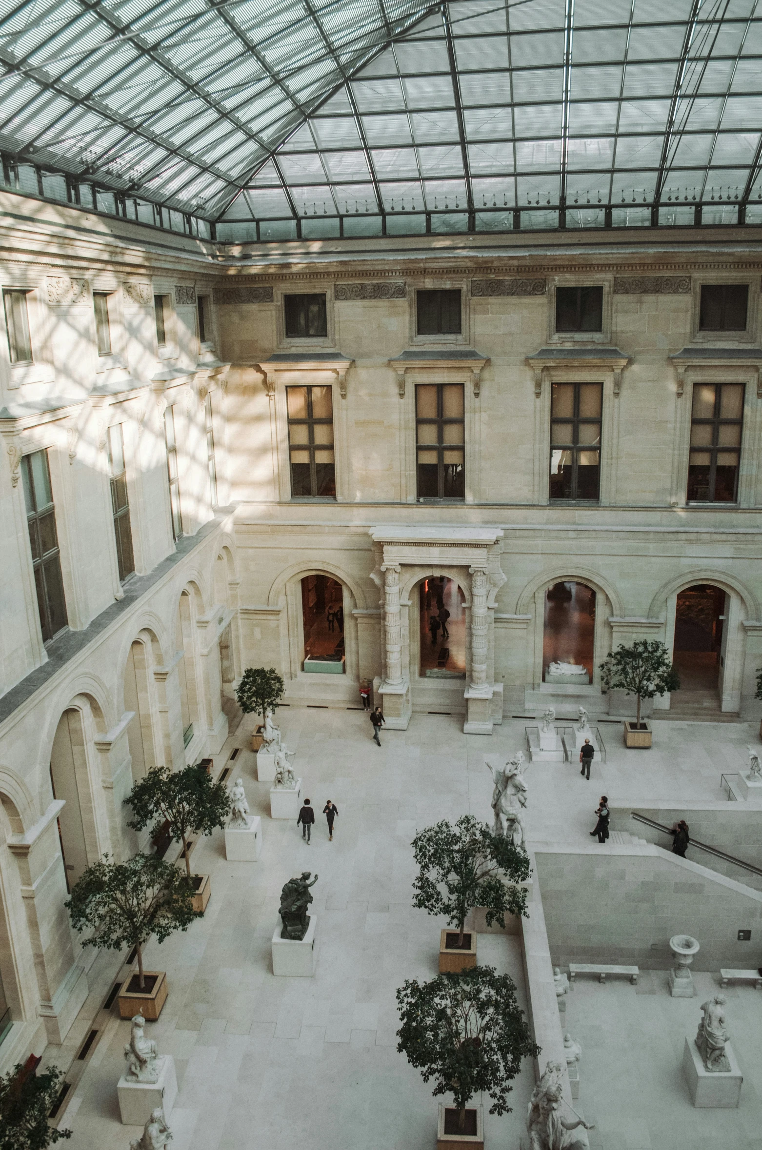 a large building with a courtyard filled with people