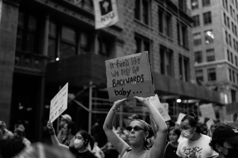 women holding signs and protesting in the street