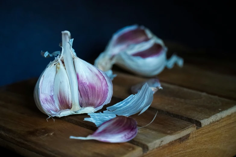 a couple of garlic bulbs that are on a  board