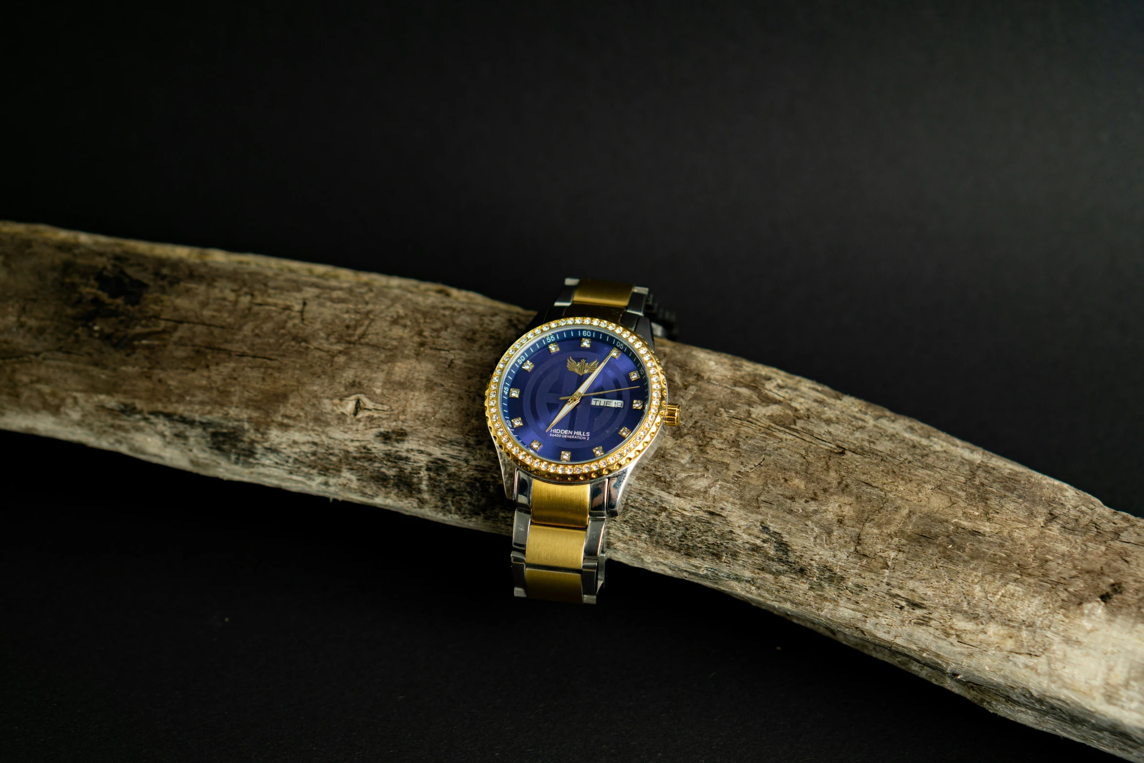 a wooden nch with a wrist watch on it