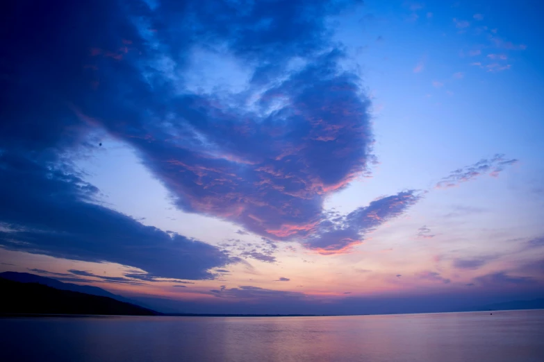 a sky with clouds above it, at dusk