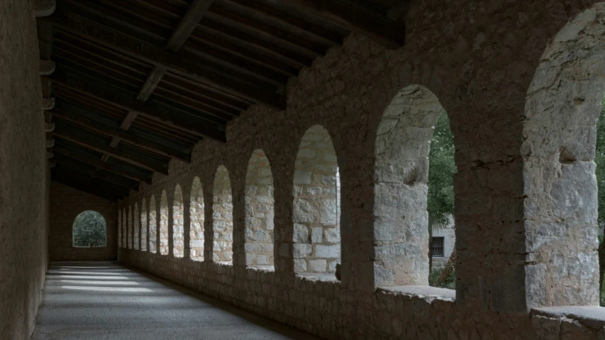 the stone arch in the side of the building is lined with columns