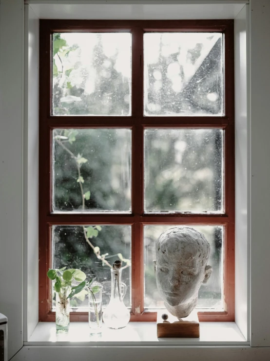 an open window displays the head of a woman