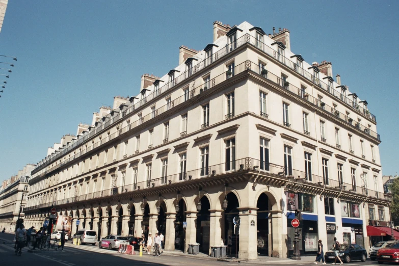 an old building with some buildings on the corner