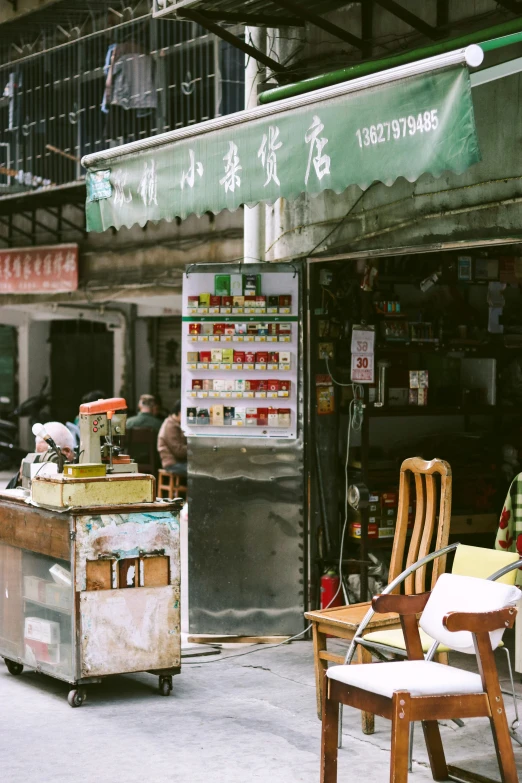 there is a small cart next to a food vendor