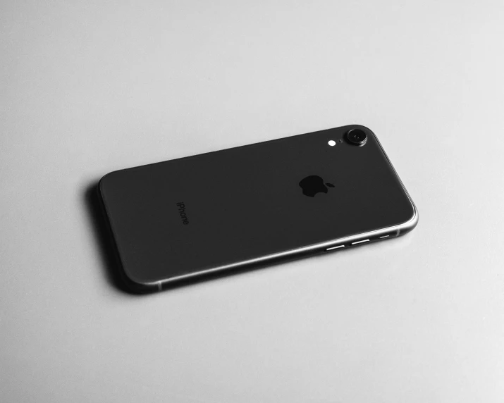 an iphone is resting on the surface of a table