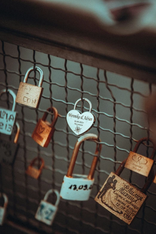 a number of padlocks on a net to be seen