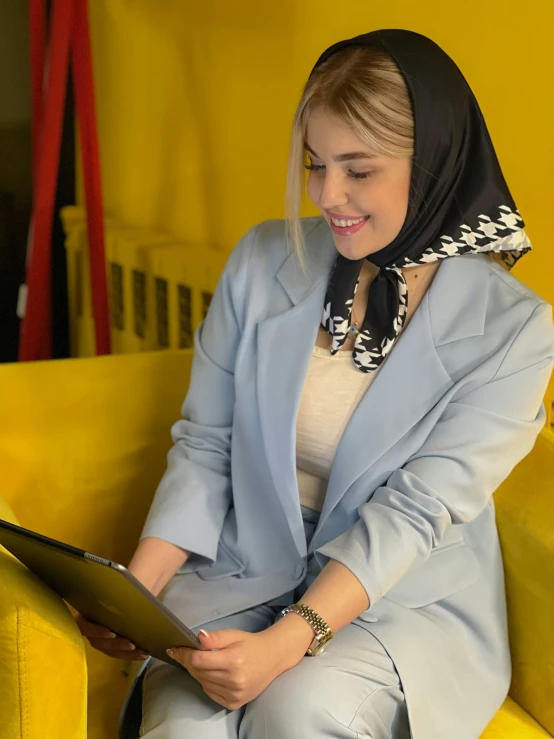 a woman sitting on a bench wearing a headscarf