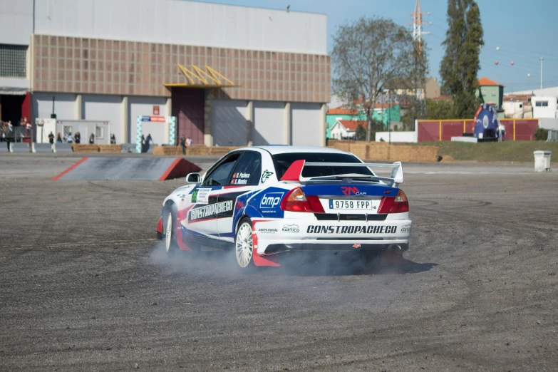 the car is smoking up some smoke in the parking lot