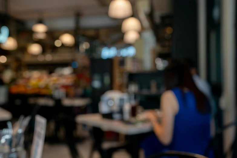 a blurry image of food and people at an outdoor dining table