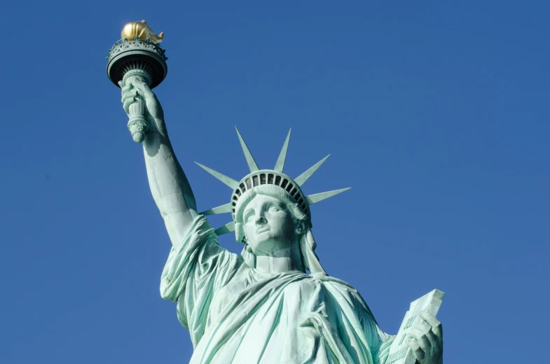 the statue of liberty is holding a torch in her hand