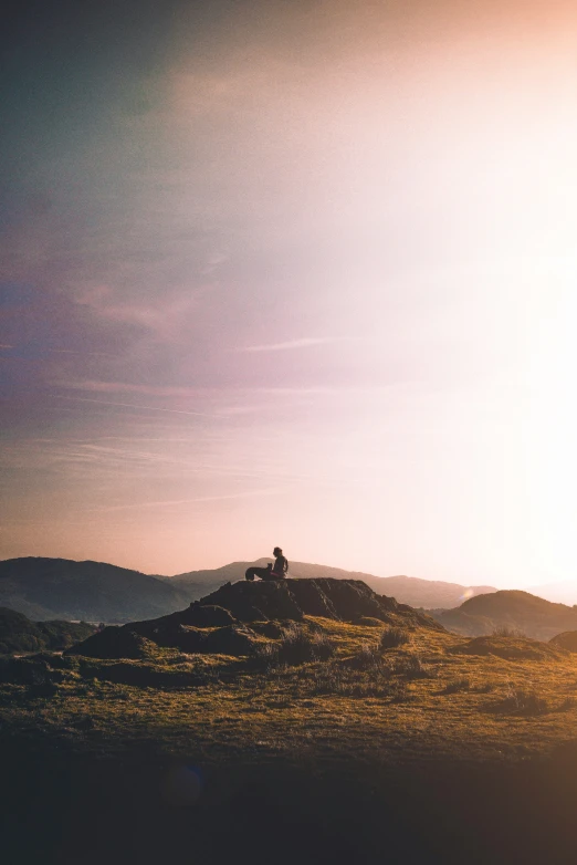 a person riding a horse on the top of a hill