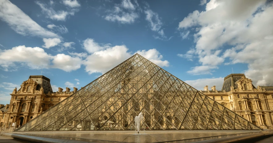 a very large pyramid sitting in front of a building