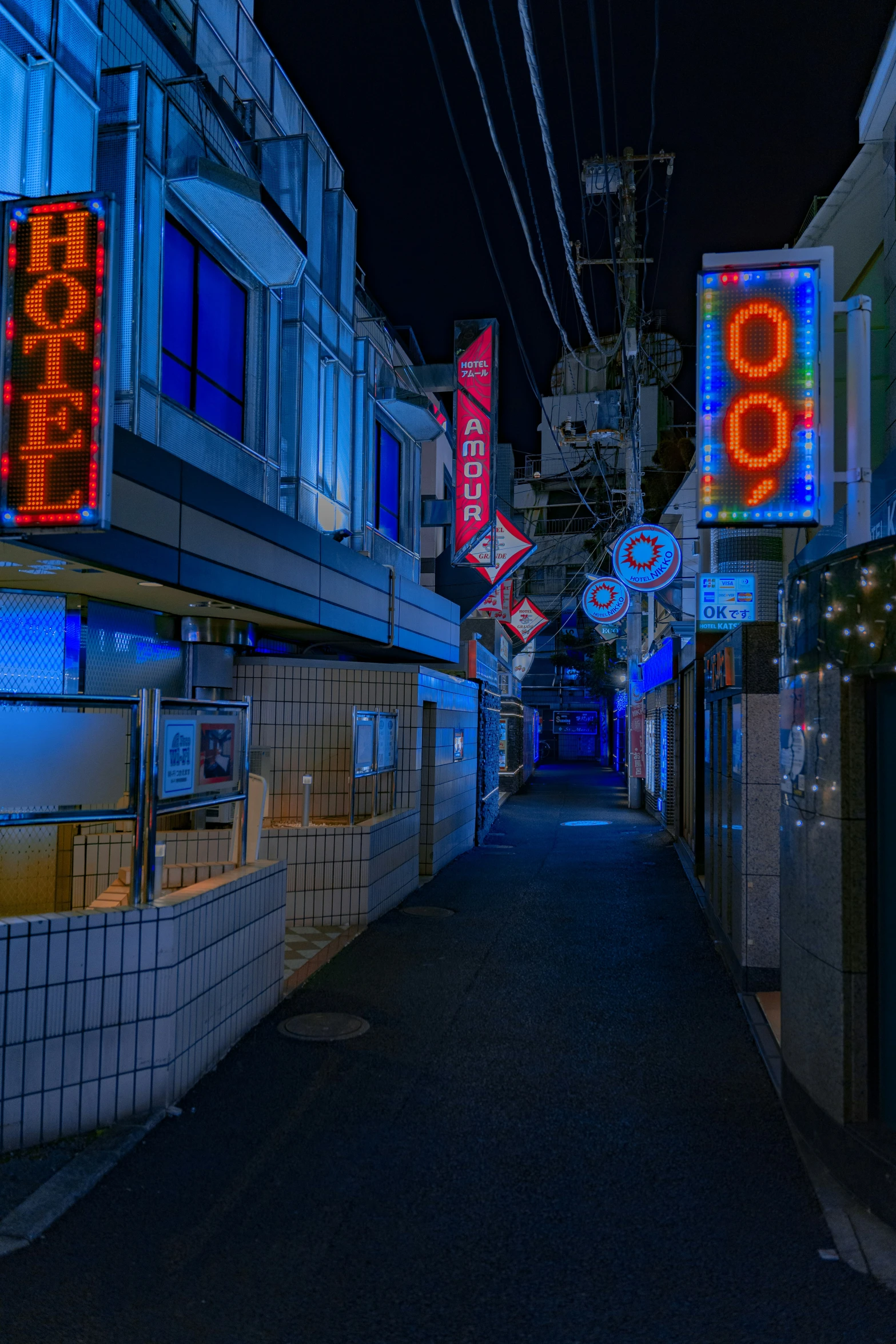 a very long alley that is glowing at night