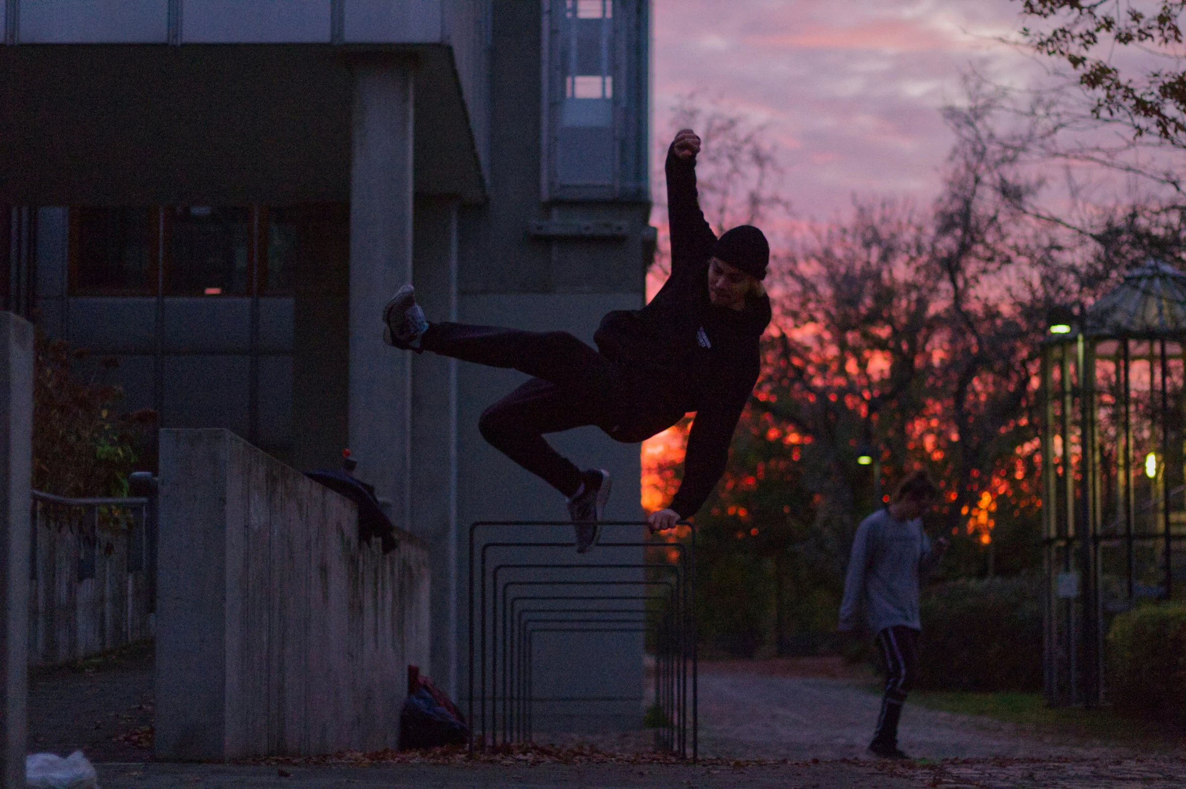 a man on a skateboard performing a trick over a wall