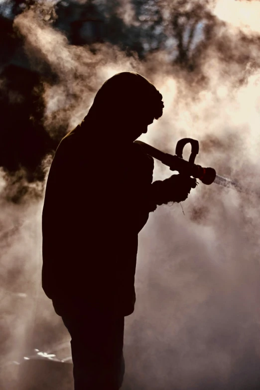 a man holding a blow gun on top of his shoulder