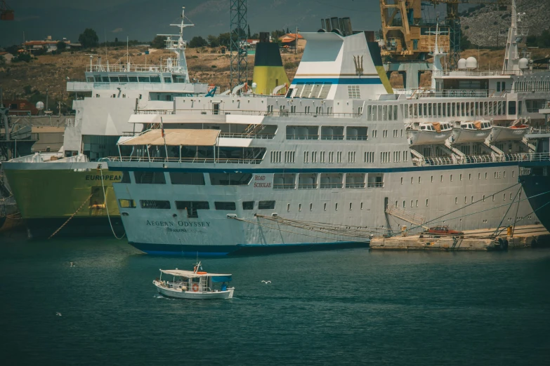 some large white ships in the water near a dock