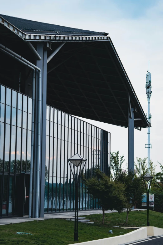 an outdoor basketball court near some building and trees