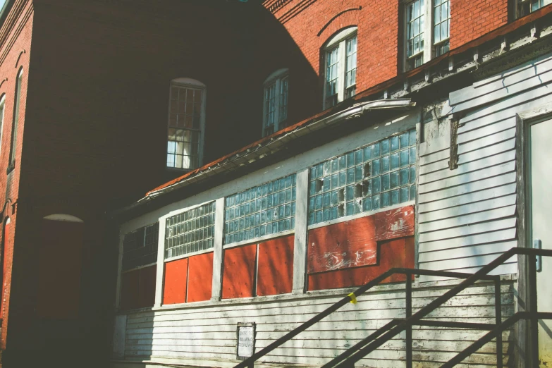 a red brick building with red shutters and a window