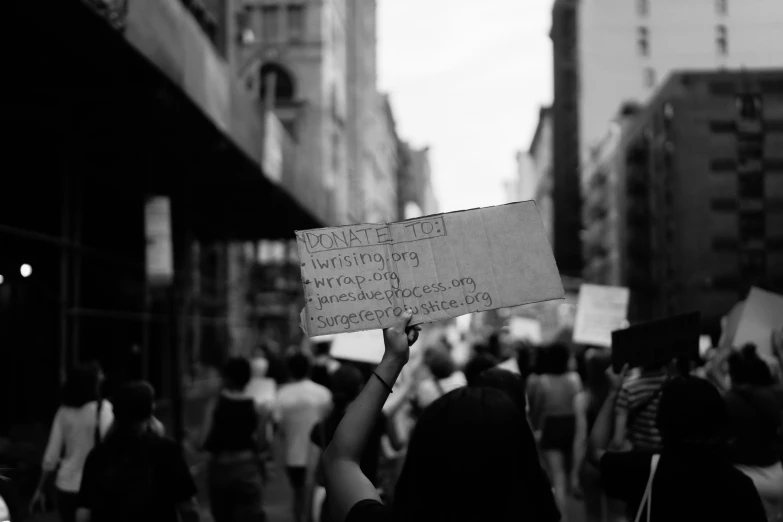 a person holding up a sign in the air