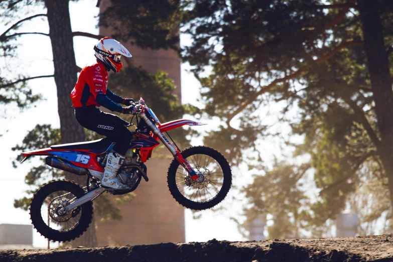 a dirt bike rider is in mid air on the dirt