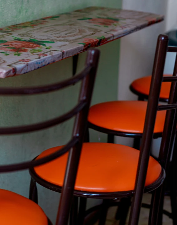 orange chairs are lined up along the wall