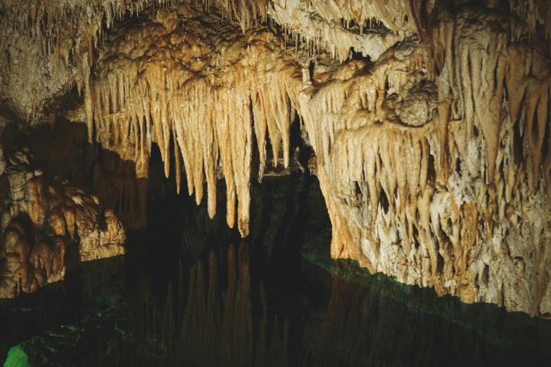 inside of a cave in the water that looks like it could fall