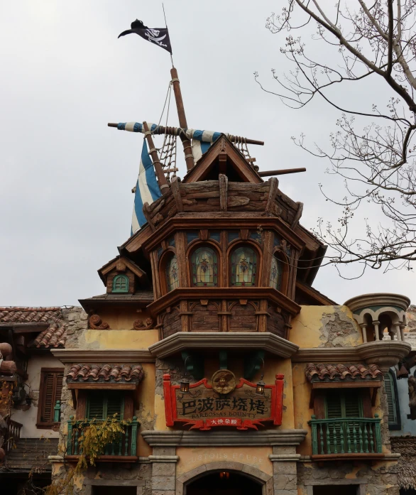 an old fashioned building with an ornate wood and stone roof