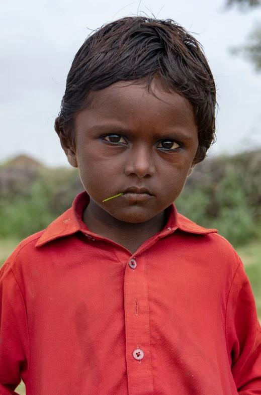 a close up of a person wearing a red shirt