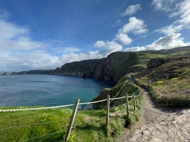 a path leading to the ocean on a sunny day