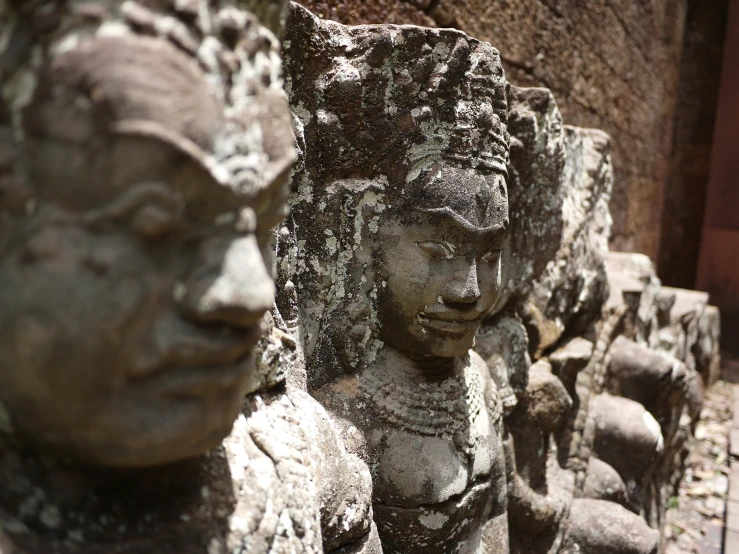 stone sculptures line the sides of a large structure