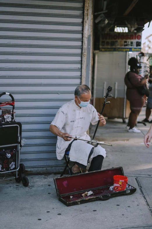 a man sitting on top of luggage next to a building