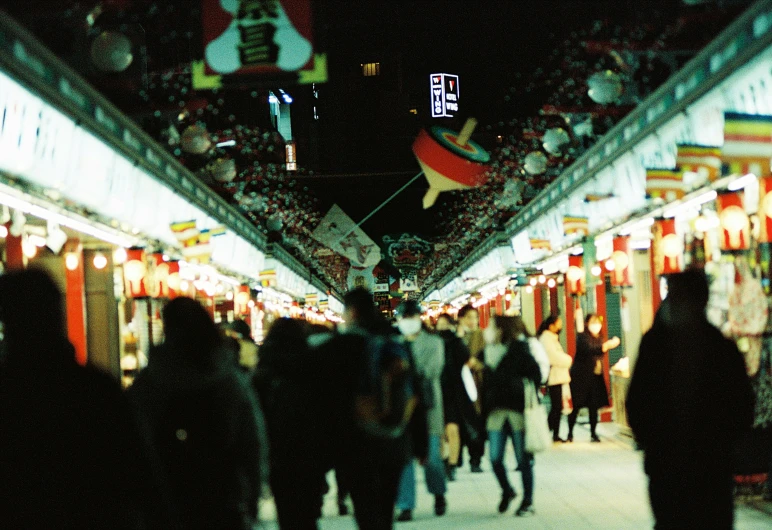 people walking along an event in a market