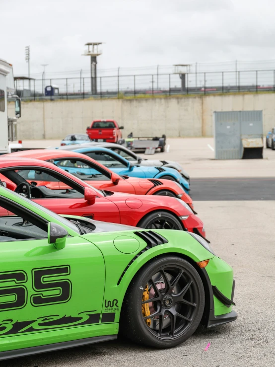 a number of different colored cars parked next to each other